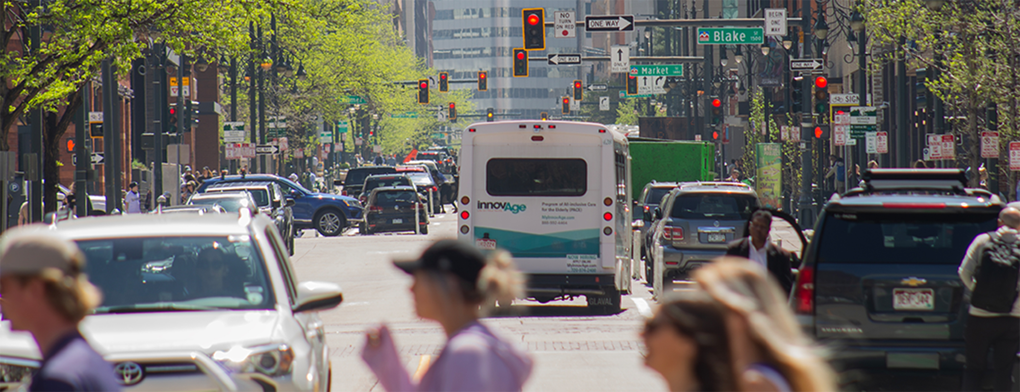 Image of vehicle traffic and people crossing the street